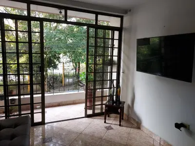 a living room with an open door to a patio at Apartamento cerca Mall La Central y Estación Tranvía in Medellín