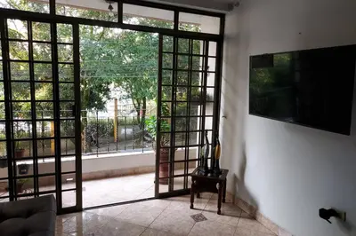 a living room with an open door to a patio at Apartamento cerca Mall La Central y Estación Tranvía in Medellín