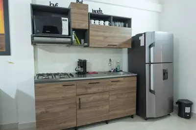 a kitchen with a stainless steel refrigerator and a microwave at El EmAnJe 1 in Jardin