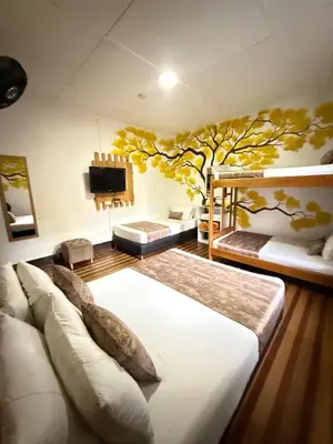 a bedroom with two bunk beds and a tv at The Garden Lleras 10 in Medellín