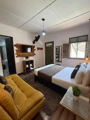 a bedroom with a large bed and a couch at The Garden Lleras 10 in Medellín