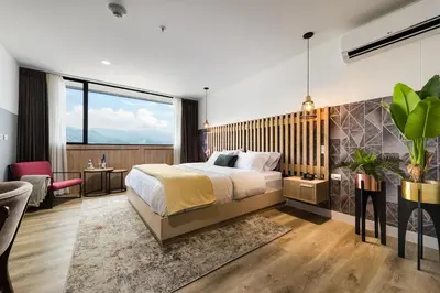 a bedroom with a bed and a desk and a chair at Go Living and Suites by Jalo in Medellín