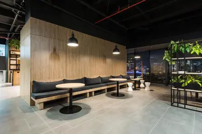 a restaurant with couches and tables and potted plants at Go Living and Suites by Jalo in Medellín