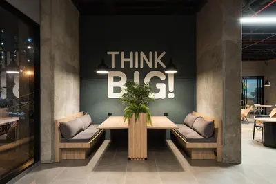 a dining room with a think big sign on the wall at Go Living and Suites by Jalo in Medellín
