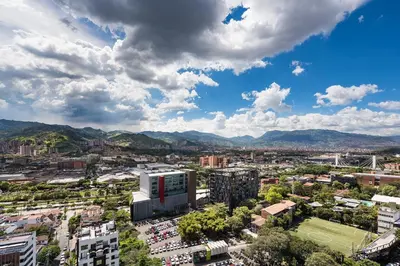 a view of a city with mountains in the background at Go Living and Suites by Jalo in Medellín