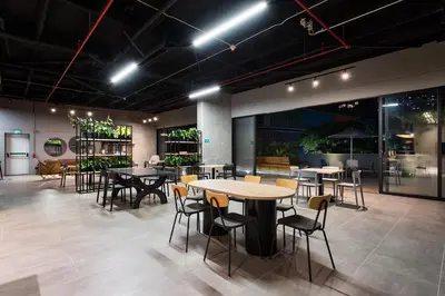 a restaurant with tables and chairs in a room at Go Living and Suites by Jalo in Medellín
