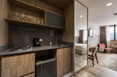 a hotel room with a kitchen and a bedroom at Go Living and Suites by Jalo in Medellín