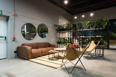 a living room with a couch and a table and chairs at Go Living and Suites by Jalo in Medellín