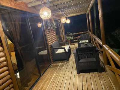 a balcony with chairs and a table and a chandelier at Mi lugar secreto in Medellín