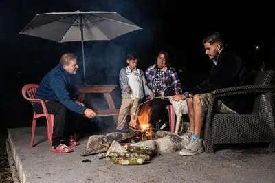 a group of people sitting around a fire at Mi lugar secreto in Medellín