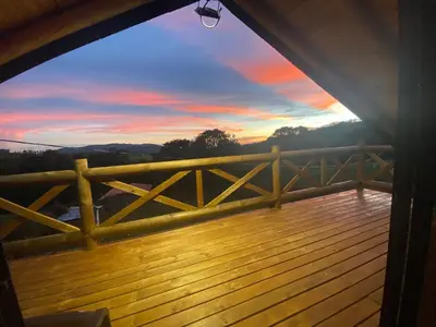 a view from the deck of a cabin with a sunset at Mi lugar secreto in Medellín