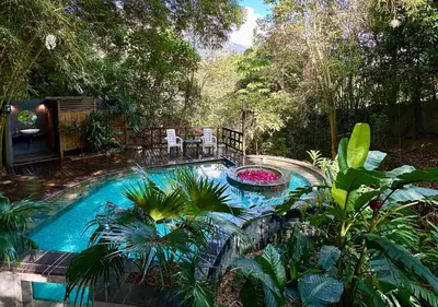 a swimming pool in the middle of a garden at All Natural Glamping in Copacabana