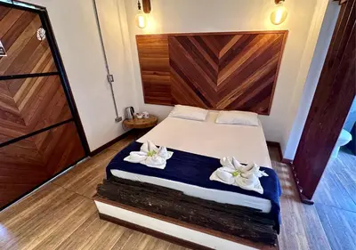a bedroom with a bed with two white flowers on it at All Natural Glamping in Copacabana