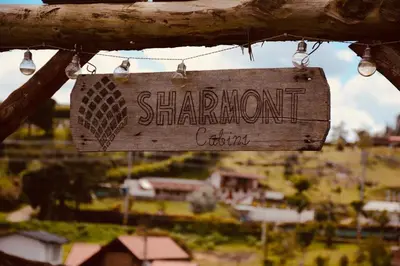 a sign that reads shandon center hanging from a tree at Glamping Cabañas Sharmont in Guarne