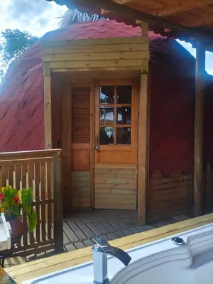 a house with a tub in front of it at Glamping Cabañas Sharmont in Guarne