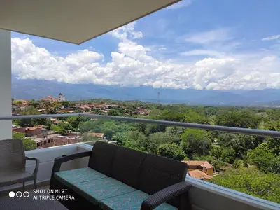 a balcony with a bench and a view of a city at Apartasol Citadela Di Sole 1104 - Santafé de Antioquia in Santa Fe de Antioquia
