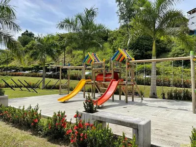 a playground with colorful slides in a park at Apartasol Citadela Di Sole 1104 - Santafé de Antioquia in Santa Fe de Antioquia
