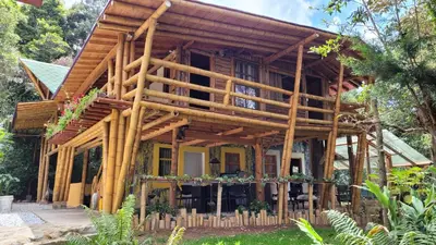 a house made out of wooden logs at Refugio en el Bosque in Medellín