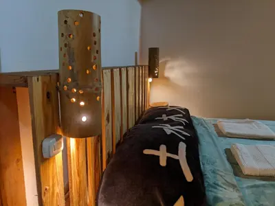 a bedroom with a bed with a wooden fence at Refugio en el Bosque in Medellín