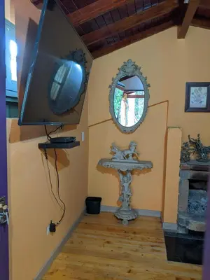 a bathroom with a sink and a tv on the wall at Refugio en el Bosque in Medellín