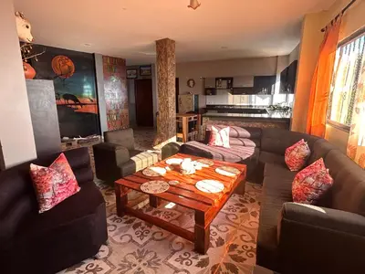 a living room with couches and a coffee table at Hotel Hostal El Castillo Santa in Santa Bárbara