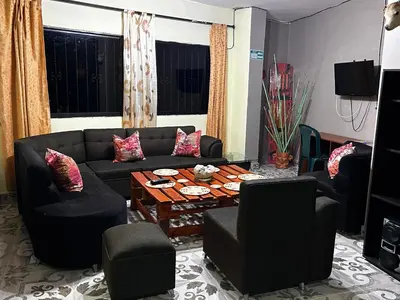 a living room with a black couch and chairs at Hotel Hostal El Castillo Santa in Santa Bárbara