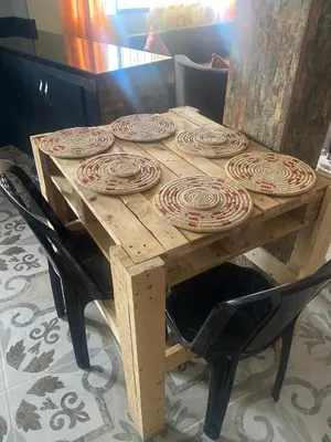 a wooden table with plates on top of it at Hotel Hostal El Castillo Santa in Santa Bárbara