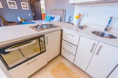 a kitchen with white cabinets and a sink at Beautiful Apartment UltraFast Internet /El Poblado in Medellín