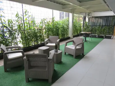 a lobby with chairs and tables and plants at HOTEL A & A SANTA ALEJANDRIA in Medellín