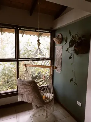 a hanging hammock in a room with a window at Casa NATIVO in Jardin