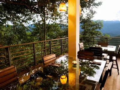 a balcony with benches and a table with a view at Casa NATIVO in Jardin