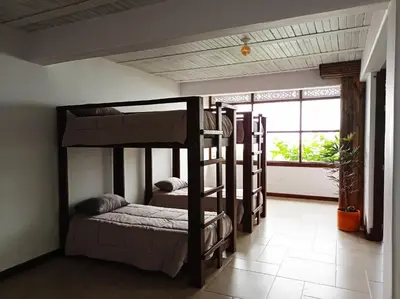 a room with three bunk beds and a window at Casa NATIVO in Jardin