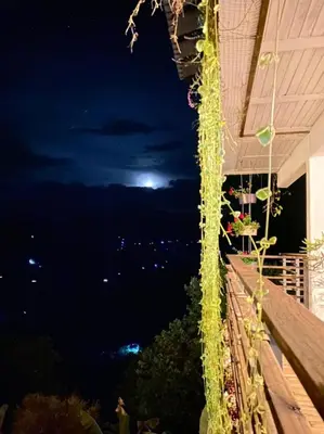 a view of the moon from a balcony at night at Casa NATIVO in Jardin