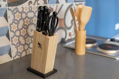 a knife block with black handled knives on a counter at Moderna casa pequeña en el Poblado MDE A106 in Medellín