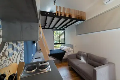 a kitchen and living room with a couch and a stove at Moderna casa pequeña en el Poblado MDE A106 in Medellín