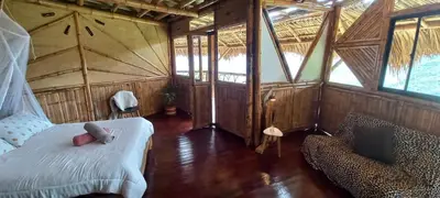 a bedroom with a bed and a couch in a room at Ecohotel Soplo del Tambo in Cocorná