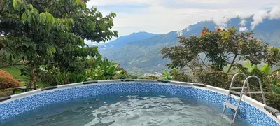 a swimming pool with a view of the mountains at Ecohotel Soplo del Tambo in Cocorná