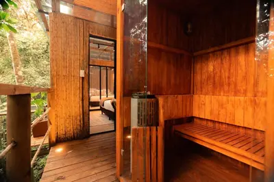 a sauna with a bench in a wooden room at BubbleSky Glamping Guatapé in Guatapé