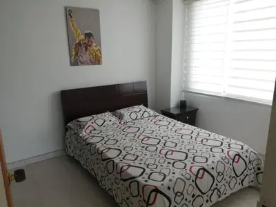 a bedroom with a bed and a picture on the wall at Casa 4 in Medellín