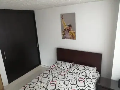 a bedroom with a bed and a picture on the wall at Casa 4 in Medellín
