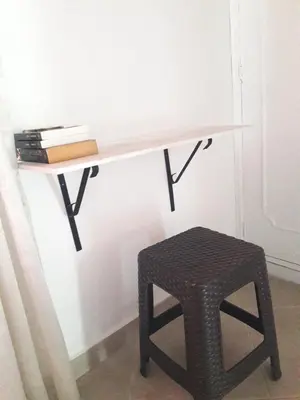 a desk with a stool next to a wall at Casa 4 in Medellín