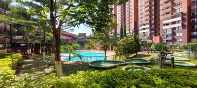 a playground with a swimming pool in a city at Apartamento en Calasanz con piscina y parqueadero in Medellín