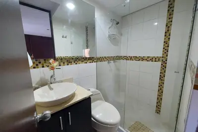 a bathroom with a toilet and a sink and a shower at Apartamento en Calasanz con piscina y parqueadero in Medellín
