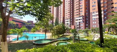 a playground in a city with a swimming pool at Apartamento en Calasanz con piscina y parqueadero in Medellín
