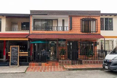 a brick building with a restaurant on a street at Ayenda Casa San Pablo in Medellín