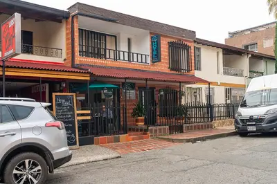 a white car parked in front of a building at Ayenda Casa San Pablo in Medellín