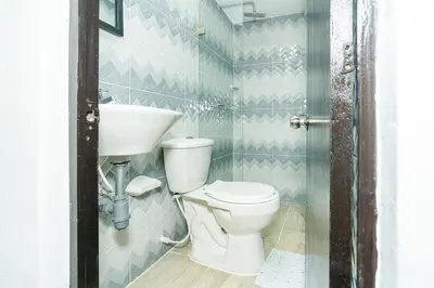 a bathroom with a toilet and a sink at Ayenda Casa San Pablo in Medellín