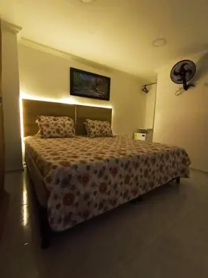 a bedroom with a large bed in a room at Hotel Eterna Primavera in Medellín