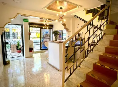 a hallway with a staircase in a house at Hotel Eterna Primavera in Medellín