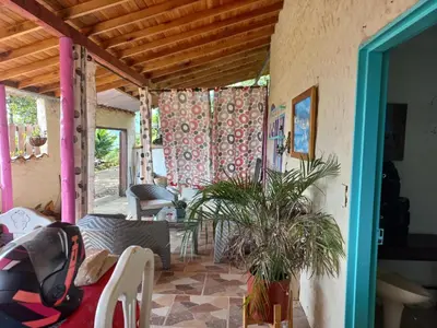 a living room with a porch with a couch and plants at Cabaña Noche De Luna in Jardin